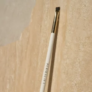 Permalift Perfect Line Brush featuring a sleek white handle and angled bristles, ideal for precise application in brow treatments