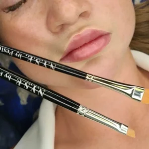 Two NYSE PMU brushes displayed on a model’s face, showcasing their high-quality synthetic bristles for precise brow and lip shading