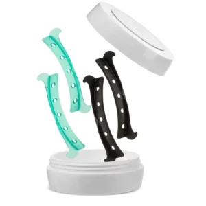 InLei Lash Stopper shields in teal and black with precision holes for secure lash lift placement, shown floating above a white storage case